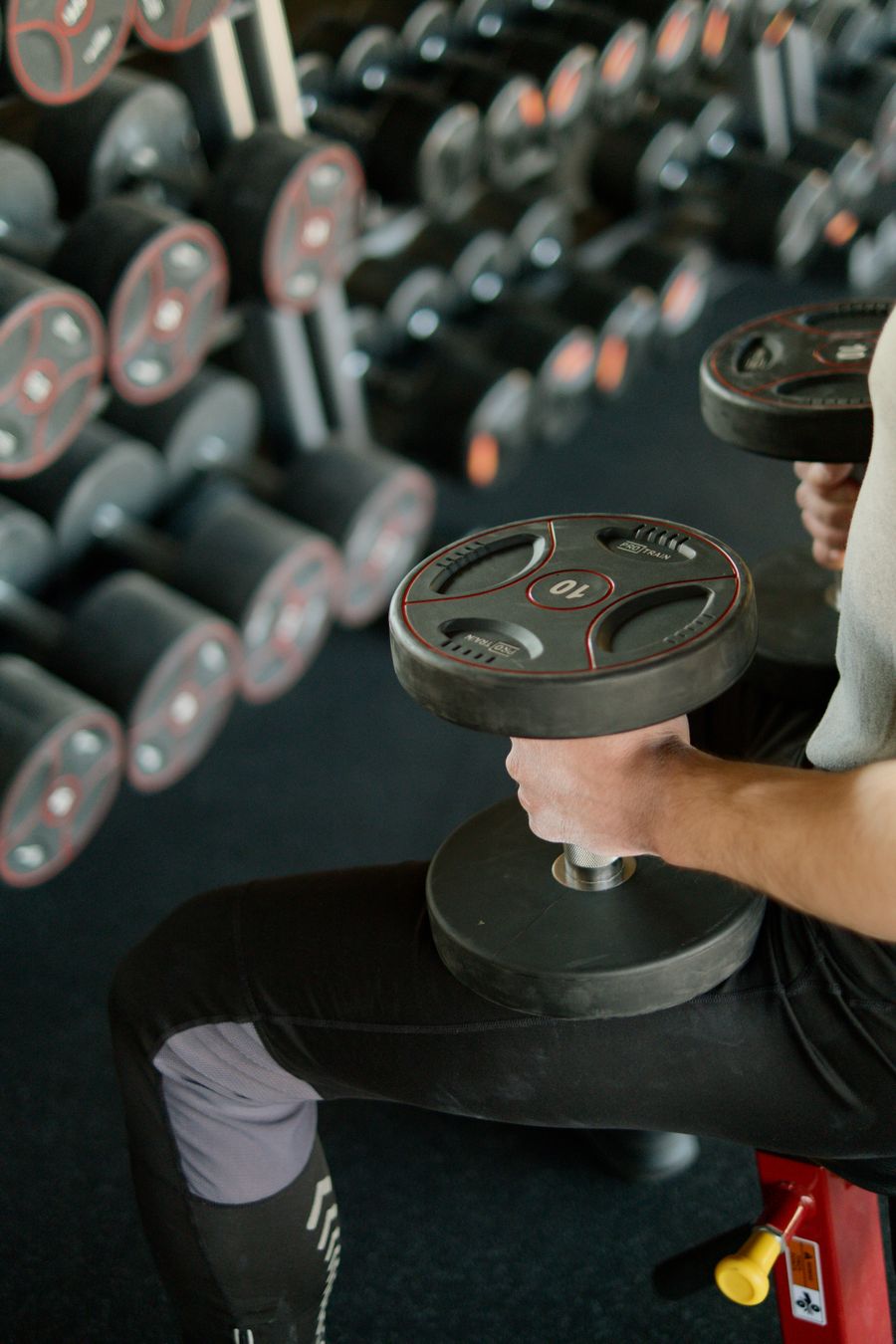 Client seated with dumbbell during a training session